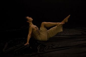 Dancer on stage in beige coloured clothing