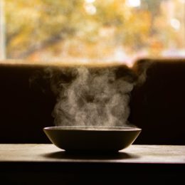 Steaming soup bowl on coffee table