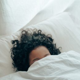 Unrecognisable person sleeping in bed