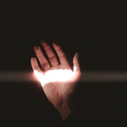 A left hand with ray of light across the palm